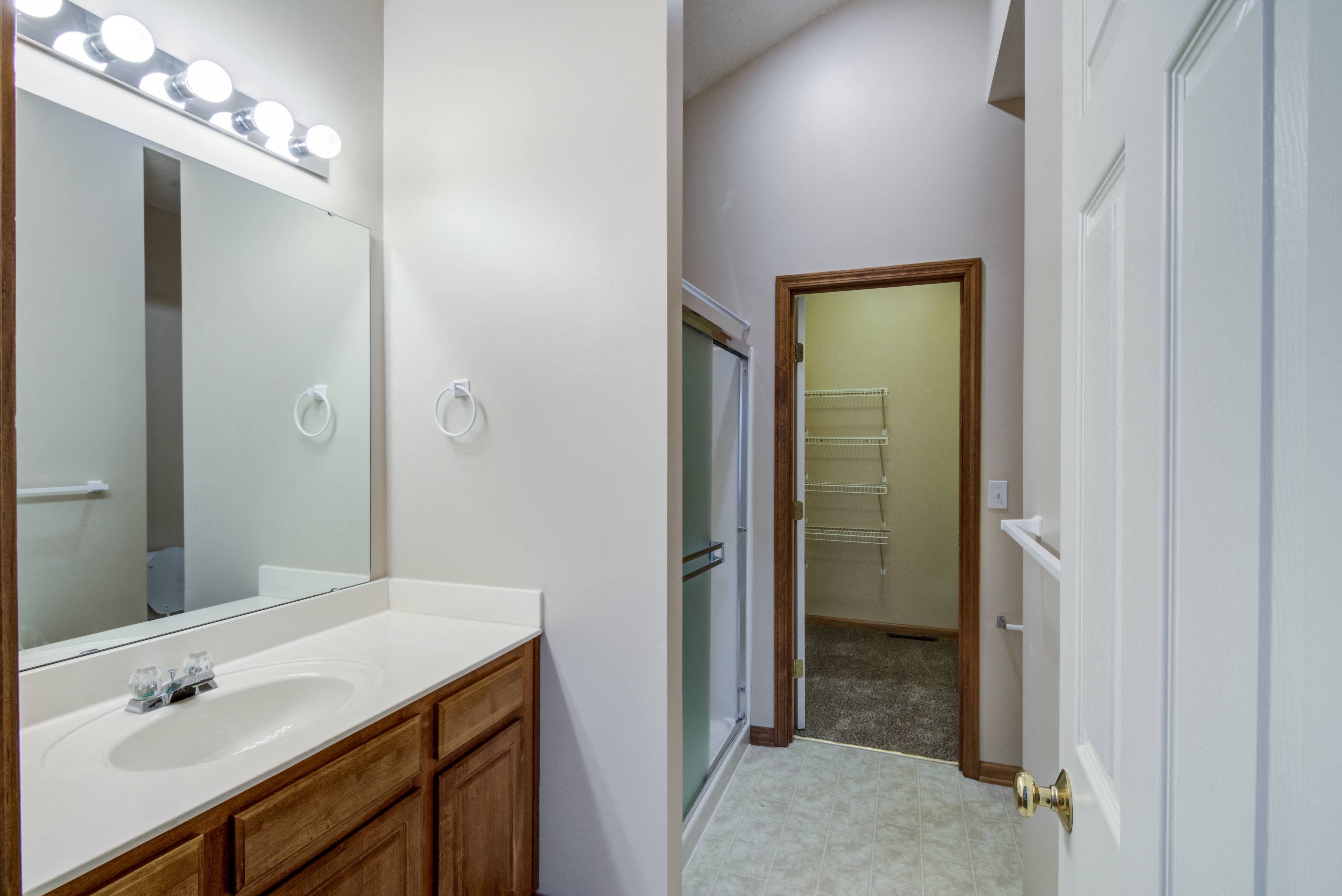 full carpeted bathroom. shower with sliding glass panels